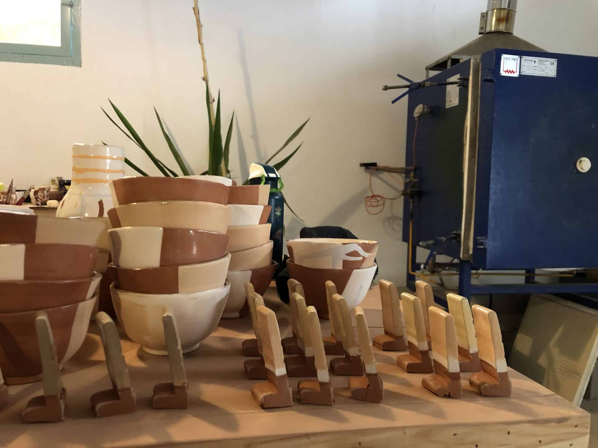 Interior of 1020° pottery studio in Taghazout, showing custom bowls, tools, and a kiln, creative space